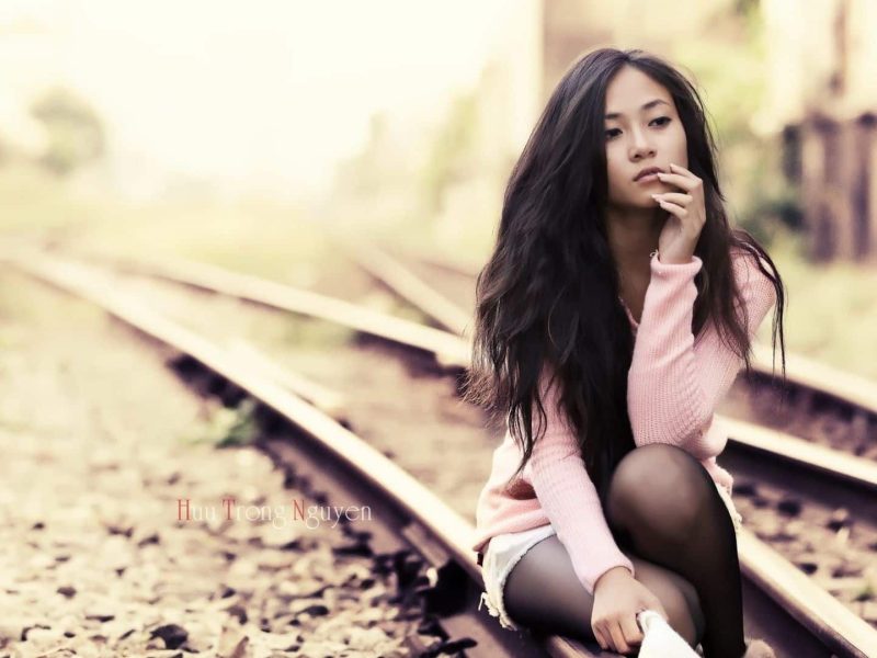 Asian Girl Sitting On The Railway